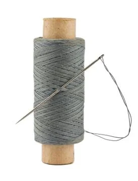 Spool of thread and needle Stock Photos