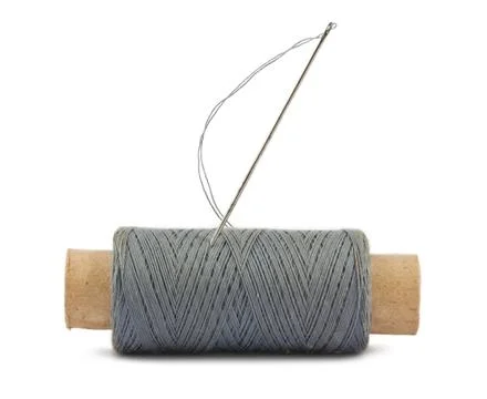Spool of thread and needle Stock Photos