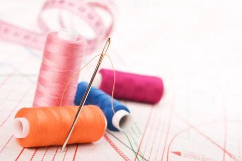 Spool of thread and needle. sew accessories. Stock Photos