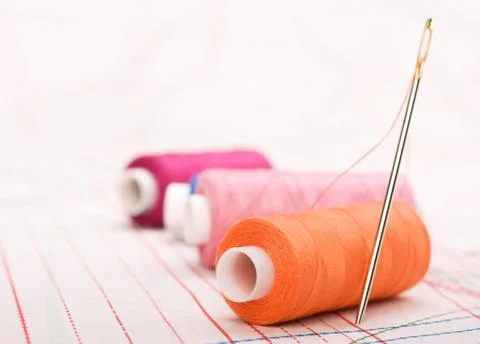 Spool of thread and needle. sew accessories. Stock Photos