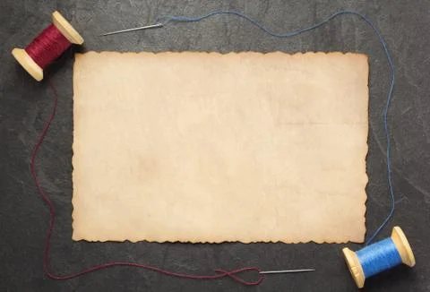 Spool of thread and needle on slate stone Stock Photos
