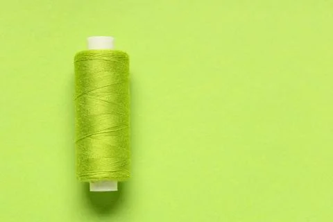 Spool of thread on green background Stock Photos