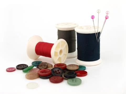A spool of thread, needle and button Stock Photos