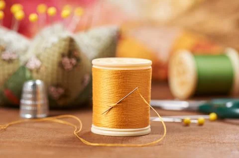 Spool of thread with needle on the background accessories for quilting Fotos Stock