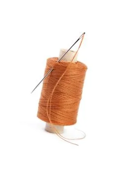 Spool of thread with a needle Stock Photos