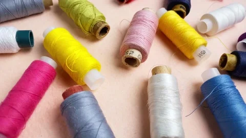 Spool of thread rotating on pink background. 動画素材 232308390