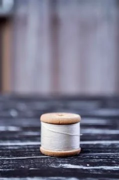 The spool of thread on the table. Thread on a reel for craft. Ma Stock Photos