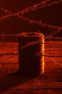 Spool of thread on wooden surface Stock Photos