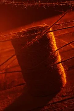 Spool of thread on wooden surface 写真素材