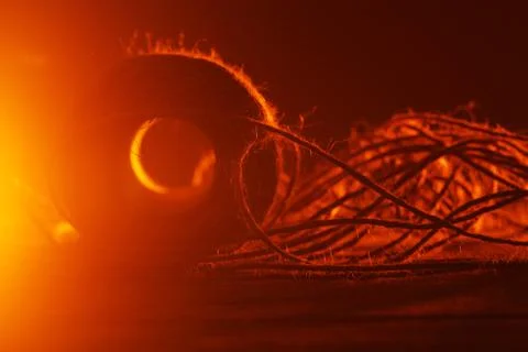 Spool of thread on wooden surface Stock Photos