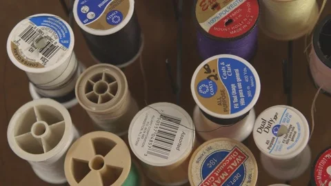 Spool Of threads arranged on table Stock Footage 83861251
