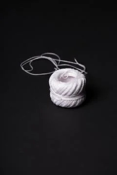 Spool of white thread over a black background Stock-Fotos