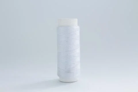 Spool of white thread on a white background Foto stock