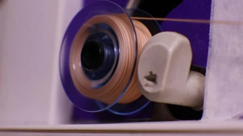 Spool winding process on sewing machine bobbin Stock Footage 348237424