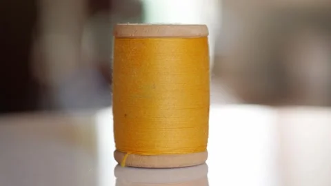 Spool of yellow cotton thread for sewing close-up 動画素材 281590446