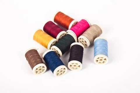 Spools and bobbins of thread for multicolor sewing, isolated on white backgro Stock Photos