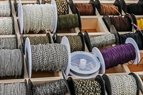 Spools with chains and colored ribbons 3 Stock Photos