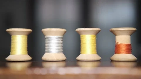 Spools of colored threads for sewing above tailor's table Stock Footage 148058986