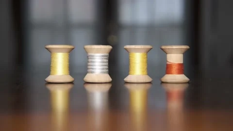 Spools of colored threads for sewing above tailor's table Stock-Footage 148060056