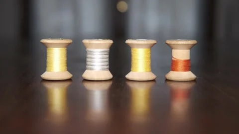 Spools of colored threads for sewing above tailor's table Видео 148060392