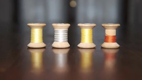 Spools of colored threads for sewing above tailor's table Видео 148067676