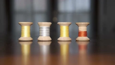 Spools of colored threads for sewing above tailor's table Видео 148069637