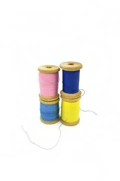 Spools of multi-colored threads on a white background Stock Photos
