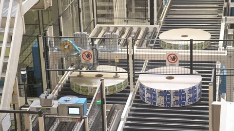 Spools of paper. Roll of paper is on the tape. Automated process at the factory. Stock Footage 105343891