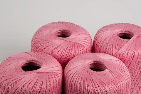 Spools of pink thread on a gray background. Photo for a banner. Stock Photos