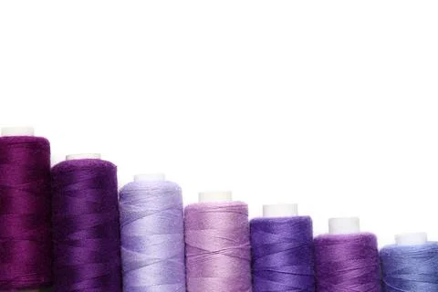 Spools of purple thread on white background 写真素材