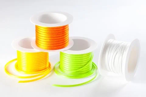 Spools of ribbon on white background Stock Photos