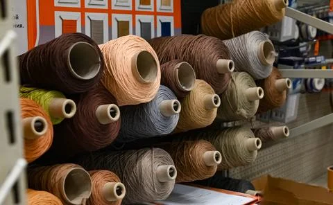 Spools of sewing thread for industrial overlock close-up. Stock Photos