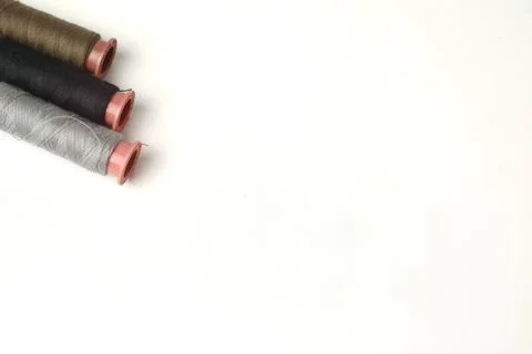 Spools of sewing thread used in the fabric and textile industry, different .. Stock Photos