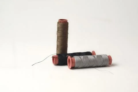 Spools of sewing thread used in the fabric and textile industry, different .. Stock Photos