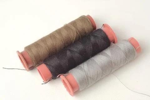 Spools of sewing thread used in the fabric and textile industry, different .. Stock Photos