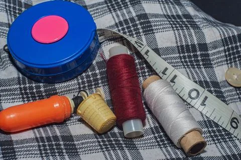 Spools of thread and basic sewing tools, including, needles and tape measur.. Stock Photos