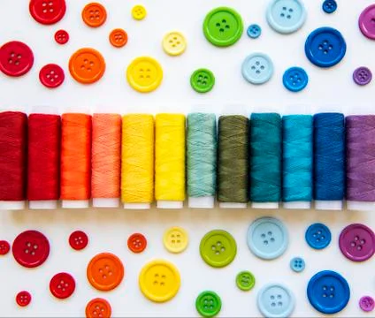 Spools of thread and buttons on the colors  of the rainbows Stock Photos