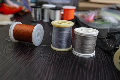 Spools of thread and close-up set of various fly tying accessories for fly .. Stock Photos
