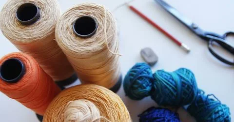 Spools of thread and sewing accessories on a table, with copy space Stock Photos