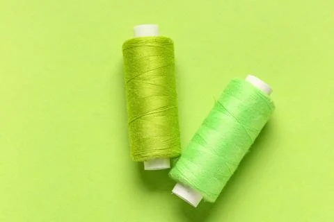 Spools of thread on green background 写真素材