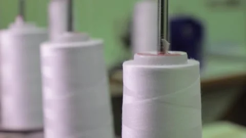 Spools of thread on a loom in a textile factory. Close up Stock Footage 168579647