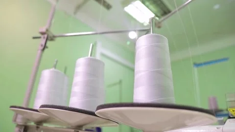 Spools of thread on a loom in a textile factory Stock Footage 168579812