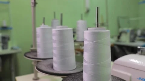 Spools of thread on a loom in a textile factory Stock Footage 168758658