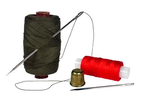 Spools of thread, needles on a white background Stock Photos