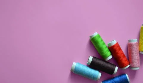 Spools of thread on a pink background, a banner for an atelier, tailoring, .. Stock Photos