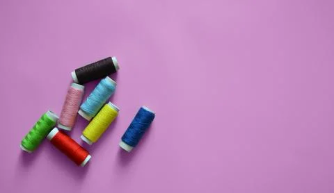 Spools of thread on a pink background, a banner for an atelier, tailoring, .. Stock Photos