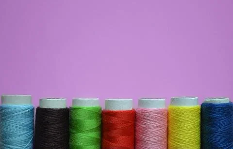 Spools of thread on a pink background, tailoring, photos for a sewing works.. Stock Photos