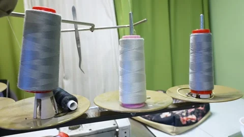 Spools of thread on a professional sewing machine in a workshop 스톡 동영상 339754737