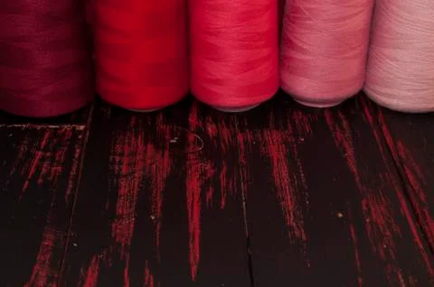 Spools of thread in red scale sewing Stock Photos