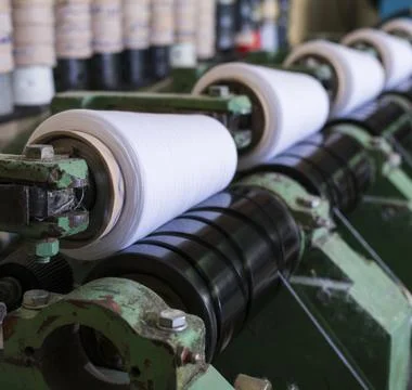 Spools with thread at rewinding machine view Stock Photos